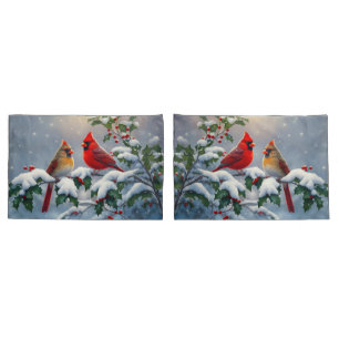 Cardeais vermelhos e Holly na neve