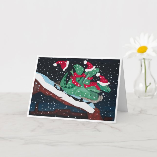 Cartão A whimsical holiday card with sledding dinosaurs (Planta pequena)