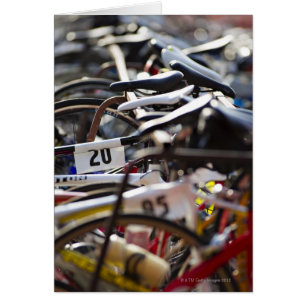 Cartão As bicicletas na cremalheira em um triathlon