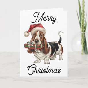 Cartão Basset Hound no Papai Noel presente na boca