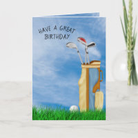 Bola de golfe e saco no aniversário de grama