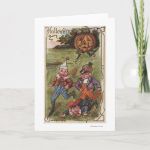 Cartão Boys Running From Pumpkin Man in Field