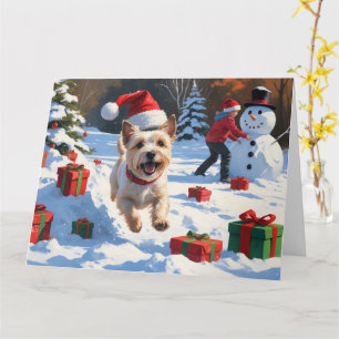 Cartão Cairn Terrier Correndo na Neve com Chapéu de Natal