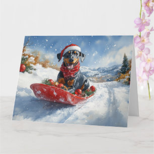 Cartão Cão Doberman em Trenó Deixe Nevar Natal