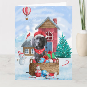 Cartão Cão Weimaraner na Casa de Natal na Neve