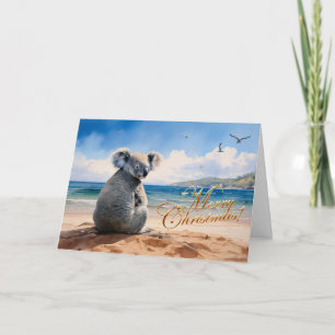 Cartão Coala em uma praia arenosa Feliz Natal