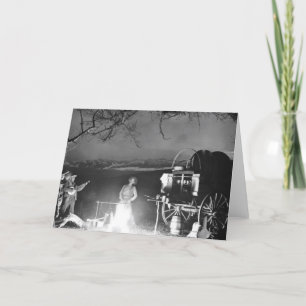 Cartão Cowboys tocando e cantando ao redor de uma fogueir