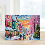 Cartão Cozy Winter Street Scene Arte Moderna<br><div class="desc">Uma pintura artística acolhedora moderna que retrata uma encantadora cena de inverno com edifícios brilhantemente coloridos, uma bela árvore de Natal decorada, e pessoas rolando através de neve suavemente caindo. O uso de cores pastéis brilhantes adiciona um toque quente e convidativo ao frio inverno, criando uma atmosfera festiva e alegre....</div>