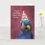 Cartão Cute Macaw Laugh to Stay Young  Birthday<br><div class="desc">This blue hyacinth macaw wearing a colorful party hat is doing his best to keep you laughing on your birthday so that you'll stay young. The cover text says "Since laughter keeps you young ... ". The inside text says "I'll do my best to keep you laughing. Happy Birthday!" All...</div>