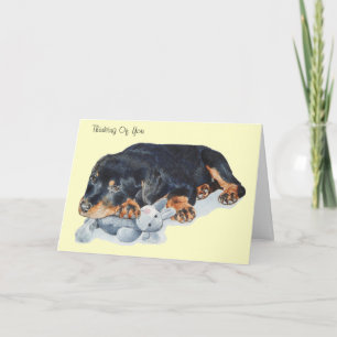 Cartão cute puppy rottweiler dog cuddling teddy bear art