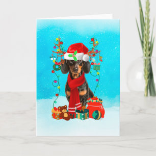 Cartão Dachshund na neve com presentes de Natal
