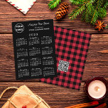 Cartão De Festividades 2023 Calendar Logo QR Code Red Black Buffalo Check<br><div class="desc">Wish your customers a Happy New Year with a custom holiday card featuring your business logo, greeting, and company name over a white 2023 calendar on a black background on the front. The back features a customizable QR code on a red and black buffalo check pattern. Replace the sample logo,...</div>