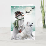 Cartão De Festividades American Eskimo With Snowman Cards<br><div class="desc">Santa and sleigh fly overhead of snowman and playful American Eskimo on Friskybizpet Christmas Card.</div>