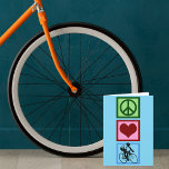 Cartão De Festividades Amor da paz que dá um ciclo o ciclista azul<br><div class="desc">Um sinal de paz verde bonito,  um coração vermelho bonito,  e uma silhueta de uma pessoa que monta uma bicicleta em um quadrado azul. Um presente bonito do Natal do ciclismo.</div>