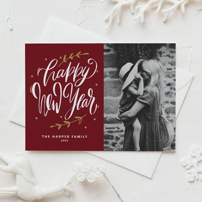 Cartão De Festividades Burgundy Calligraphy and Wreath New Year Photo (Customizable burgundy photo Happy New Year card featuring modern calligraphy and wreath.)