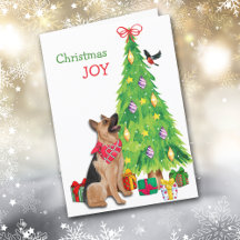 Cão german shepherd, pássaro e árvore de Natal