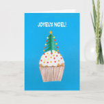 Cartão De Festividades Christmas Card, French Cupcake with Christmas Tree<br><div class="desc">A bright and cheerful French Christmas Card with a decorated Christmas Tree on top of an iced cupcake, from a handpainted paper collage by Judy Adamson. The front greeting, in white text on a blue background, is 'Joyeux Noel!' and the inside message, which you can change, is, '... et Bonne...</div>