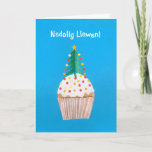 Cartão De Festividades Christmas Card (Welsh) Cupcake with Christmas Tree<br><div class="desc">A bright and cheerful Welsh Christmas Card with a decorated Christmas Tree on top of an iced cupcake, from a handpainted paper collage by Judy Adamson. The front greeting, in white text on a blue background, is 'Nadolig Llawen!' and the inside message, which you can change, is, '... a Blwyddyn...</div>