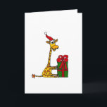 Cartão De Festividades Funny Giraffe in Santa Hat Christmas Design<br><div class="desc">Wonderful funny giraffe wearing a Santa hat and opening a Christmas present original Christmas art.  Can also add custom text and change background color when ordering.</div>