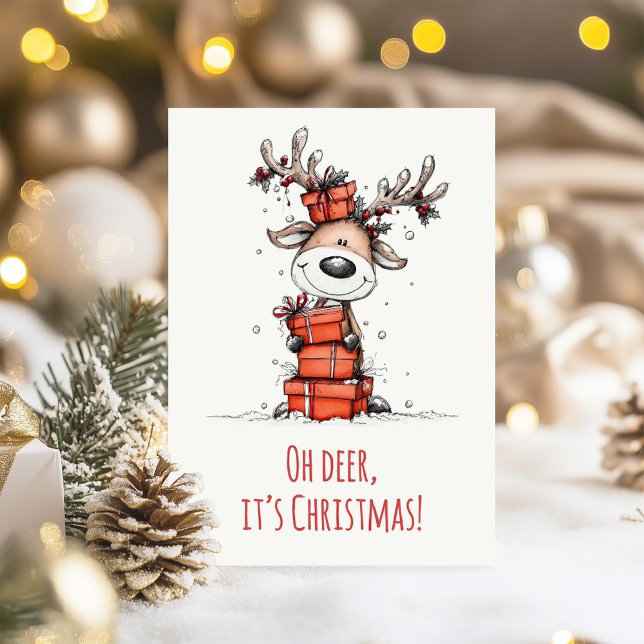 Cartão De Festividades Funny Reindeer – “Oh Deer, It’s Christmas"  (Funny Reindeer – “Oh Deer, It’s Christmas" Holiday Card on  a table with Christmas decoration)