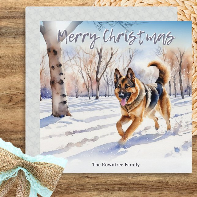 Cartão De Festividades German shepherd Cachorro Alsaciano Natal (A Christmas card with watercolor style illustration of a German shepherd dog in the winter snow)