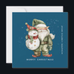 Cartão De Festividades Gnome e Snowman Feliz Natal Comercial Flat<br><div class="desc">Um gnomo vestido de vermelho fica ao lado de um boneco de neve com um chapéu de elfo verde e um cachecol vermelho. Eles estão cercados por uma poeira de neve branca que pop sobre o fundo azul escuro. A estética minimalista é criada por um simples Feliz Natal abaixo e...</div>