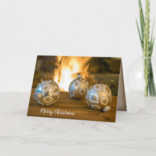 Cartão De Festividades gold Christmas ornaments by fireplace