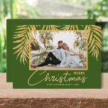 Cartão De Festividades Gold Palms Topical Christmas Photo<br><div class="desc">Glamorous faux gold glitter palm fronds on a dark green background highlight your favorite photo on these holiday Christmas photo cards. Merry Christmas and your names on the bottom in chic lettering. High Definition for best quality. MORE COLORS and multi-photo style done for you in our collection.</div>