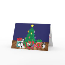 Huskies Playing Under the Christmas Tree Card