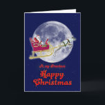 Cartão De Festividades Merry Christmas to grandson, santa in his sleigh<br><div class="desc">A cheerful Christmas card showing Santa Claus riding in his sleigh pulled by a reindeer. They are flying past the full moon in the sky. A good card for a business to send.</div>