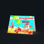 Cartão De Festividades Miami Felry Papais noeis de Natal e Flamingo Beach<br><div class="desc">Este cartões de natal de Feliz Natal apresenta Santa Clause em Miami Beach. Ele está relaxando aproveitando o sol, palmeiras, seu cachimbo e um flamingo rosa engraçado vestindo um chapéu e uma coroa de Papai Noel. Saudação dentro ~ "Desejos mais quentes do nosso Paraíso Feriado para o seu... ". Todo...</div>