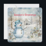 Cartão De Festividades Pastel Blue Snowman e a cena de inverno da velha i<br><div class="desc">Um delicado azul pastel domina a cena da floresta de inverno com um boneco de neve e uma velha igreja neste cartão de Natal que envia "Saudações da Estação". Personalizado no verso com seu nome,  é um verso adequado para os feriados.</div>