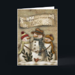 Cartão De Festividades Primitive Snowman Christmas Greeting Card<br><div class="desc">Primitive Christmas greeting card with a snowman reliaxing in the night sky with the snow flakes falling..</div>