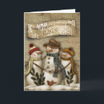 Cartão De Festividades Primitive Snowman Christmas Greeting Card<br><div class="desc">Primitive Christmas greeting card with a snowman reliaxing in the night sky with the snow flakes falling..</div>