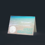 Cartão De Festividades Sand Dollar Beach Tropical Christmas Cards<br><div class="desc">Tropical beach and sand dollar Christmas cards.  Pretty turquoise and aqua blue water is the background for chunky,  open font style greeting.  Customize the text on the front and inside.  A single white sand dollar,  on a sandy beach,  decorates the front and is the background for text inside.</div>
