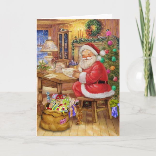 Cartão De Festividades Santa Claus working on his desk (Frente)