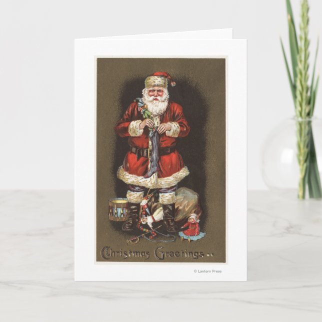 Cartão De Festividades Santa Stuffing Stocking with Nutcracker (Frente)