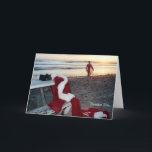 Cartão De Festividades Santa surfs the day after Christmas<br><div class="desc">I call this card December 26th. It was the first in a series that I created to combine Santa's love of all things beach and especially surfing. What else would Santa do on his first day off!</div>