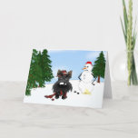 Cartão De Festividades Scottish Terrier Winter Scene<br><div class="desc">Unique Scottish Terrier winter wonderland design. Scottish Terrier with a bit of snow on his nose. Irritated snowman looks on. To ward off the cold the Scottish Terrier has on a scarf and hat that are the colors of his country.</div>