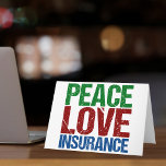 Cartão De Festividades Seguro de Paz e Amor<br><div class="desc">Um belo presente de Natal do agente de seguros com cartas verdes,  vermelhas e azuis que leem o Peace Love Insurance. presente de excelente para seus colegas de seguros.</div>