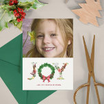 Cartão De Festividades Simple floral Christmas wreath joy script photo<br><div class="desc">Fancy modern traditional Christmas JOY floral script lettering with red holly berries,  fir branches wreath and coral red bow. Personalize this charming winter holiday family photo card with your photo (horizontal oriented) and text!</div>