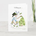 Cartão De Festividades Snowman Bluebird<br><div class="desc">Um boneco de neve enfeitando uma árvore de Natal com um pássaro azul e Holly no chapéu.</div>