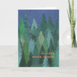 Cartão De Festividades Snowy Forest Christmas Card: Irish Gaelic<br><div class="desc">A chic Christmas Card with a forest of Christmas Trees in the snow, from a handpainted paper collage design by Judy Adamson. The greeting on the front, in orange/pink lettering, is Merry Christmas in Irish Gaelic and you can personalise the inside message. (Just one click of the button will resize...</div>