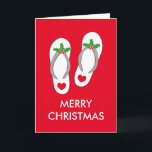 Cartão De Festividades Tropical Christmas greeting card with flip flops<br><div class="desc">Tropical Christmas greeting card with flip flops. Cute red Holiday card with custom seasons greetings and flipflops. Beach slippers with green holly leaves and red berries. Funny heart sandals design for home or company office in warm climate. Also nice as xmas party invite. Fun flipflops with x-mas decorations.</div>