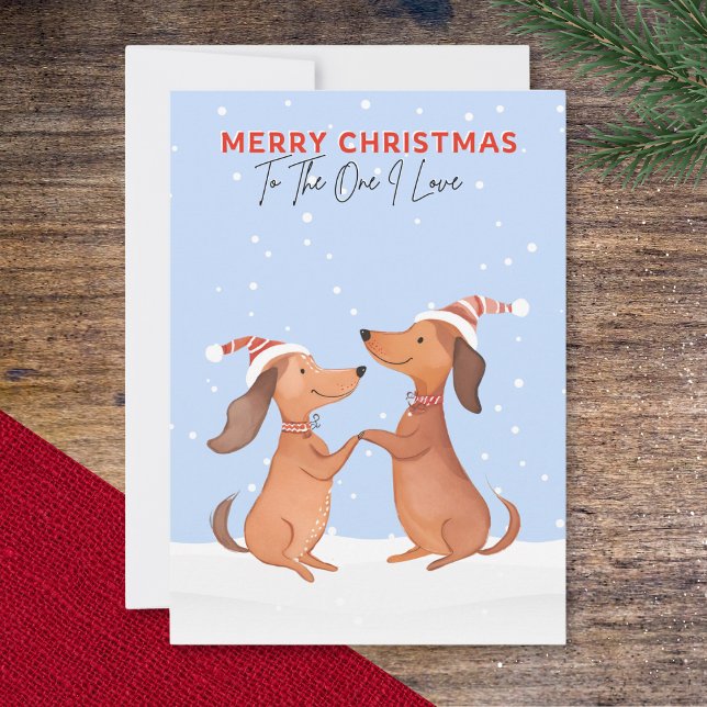 Cartão De Festividades Um Eu Adoro Feliz Natal Dachshances De Salsicha Cã (A Christmas card with two cartoon dachshunds in the snow, 'Merry Christmas' and 'To The One I Love')