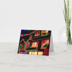 cartão de Natal com casa decorada com luzes
