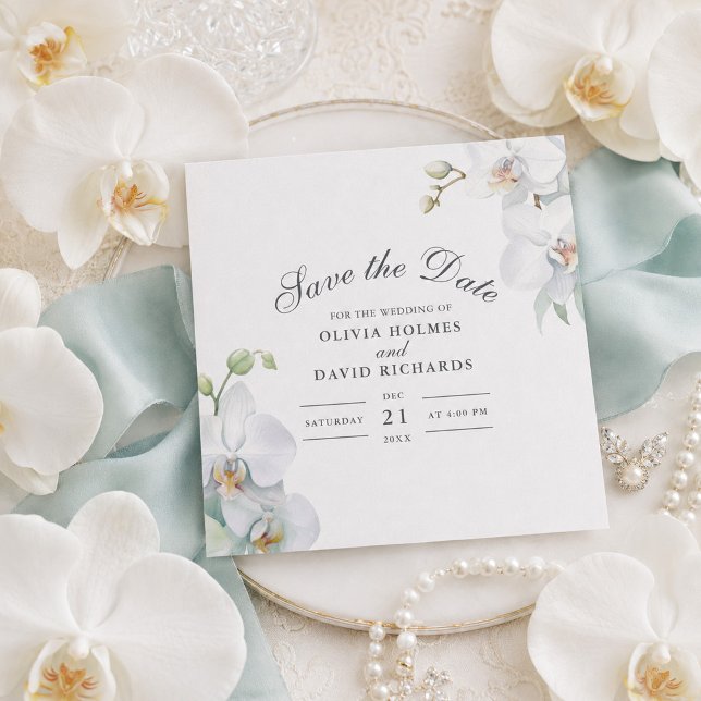 Cartão de Salvar a Data de Orquídea Branca Elegant (Modern Elegant White Orchid Save the Date Card on a table with white orchids)