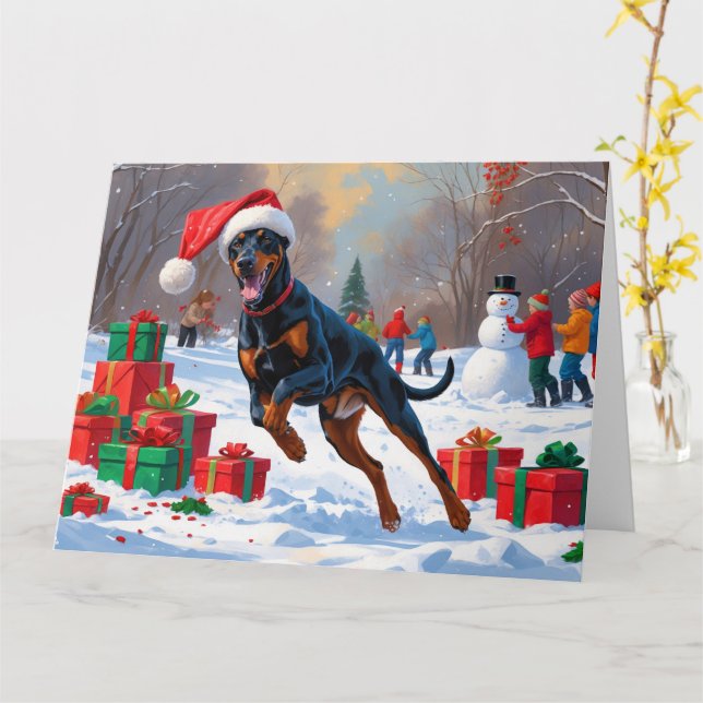 Cartão Doberman Correndo na Neve com Chapéu de Natal (Flor Amarela)