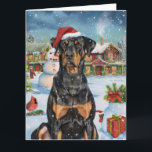 Cartão Doberman Winter Wonderland Christmas Joy<br><div class="desc">Este design festivo captura o espírito alegre da época de férias, apresentando um adorável filhote vestindo um chapéu de Papai Noel. O cachorro está aninhado numa terra maravilhosa de inverno, completo com um boneco de neve, uma árvore de Natal decorada, e presentes lindamente envoltos. Os flocos de neve caem suavemente,...</div>