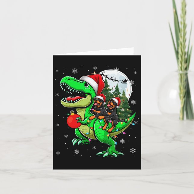 Cartão Dois Rottweilers Xmas Andando em T-rex Reindeover  (Frente)